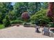 A backyard patio with a fire pit and lush landscaping provides an outdoor oasis for relaxation and entertaining at 9048 Chelsea Dr, Raleigh, NC 27603