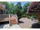 Outdoor patio with wood deck steps and landscaping, perfect for entertaining guests at 9048 Chelsea Dr, Raleigh, NC 27603