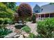 Beautiful backyard with a water feature, lush greenery, and a well-maintained stone patio offers outdoor enjoyment at 9048 Chelsea Dr, Raleigh, NC 27603