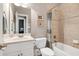 A full bath with tile shower over tub, cream vanity and framed artwork at 9048 Chelsea Dr, Raleigh, NC 27603