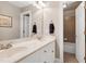 Bathroom featuring a double sink vanity with a granite countertop and a large framed mirror at 9048 Chelsea Dr, Raleigh, NC 27603