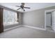 Spacious bedroom featuring neutral walls, carpet, a ceiling fan, and a window with blinds at 9048 Chelsea Dr, Raleigh, NC 27603
