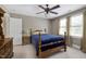 Comfortable bedroom with neutral colors, a ceiling fan, and ample natural light from two windows at 9048 Chelsea Dr, Raleigh, NC 27603