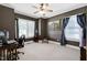 Spacious bedroom with brown walls, carpet, ceiling fan and blue curtains at 9048 Chelsea Dr, Raleigh, NC 27603