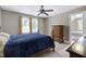 Cozy bedroom featuring a ceiling fan, warm neutral colors, and two windows with blinds at 9048 Chelsea Dr, Raleigh, NC 27603