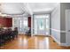 Bright dining room with hardwood floors, white trim, and a view of the front yard at 9048 Chelsea Dr, Raleigh, NC 27603