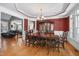 Spacious dining room featuring hardwood floors, an elegant chandelier, and large windows at 9048 Chelsea Dr, Raleigh, NC 27603