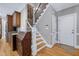 Foyer showcasing the staircase, front door, hardwood floors, and access to the kitchen at 9048 Chelsea Dr, Raleigh, NC 27603