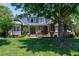 Charming brick home with manicured lawn and mature trees, offering great curb appeal at 9048 Chelsea Dr, Raleigh, NC 27603