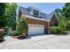 Brick house with a two-car garage, long driveway and a well-manicured lawn at 9048 Chelsea Dr, Raleigh, NC 27603