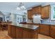 Bright open kitchen with granite countertops, center island, and access to the living space at 9048 Chelsea Dr, Raleigh, NC 27603