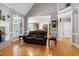 Open-concept living room featuring hardwood floors, fireplace, and staircase access at 9048 Chelsea Dr, Raleigh, NC 27603