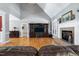 Spacious living room boasts a fireplace, TV entertainment center, and hardwood flooring at 9048 Chelsea Dr, Raleigh, NC 27603