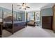 The main bedroom features a four poster bed, natural light, and sitting area at 9048 Chelsea Dr, Raleigh, NC 27603