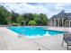 Community pool with turquoise water, lounge chairs and umbrellas, and a cabana with light blue accents at 9048 Chelsea Dr, Raleigh, NC 27603