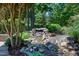 Beautiful water feature with lush foliage and natural stone accents creates a peaceful garden retreat at 9048 Chelsea Dr, Raleigh, NC 27603