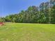 Expansive backyard with lush green grass, ideal for outdoor activities and relaxation at 100 S Sunset Ridge Dr, Willow Springs, NC 27592