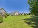 Spacious backyard with a view of the home and surrounding greenery, perfect for outdoor enjoyment at 100 S Sunset Ridge Dr, Willow Springs, NC 27592