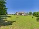 Lush backyard with ample space and view of the house, perfect for outdoor activities and gatherings at 100 S Sunset Ridge Dr, Willow Springs, NC 27592