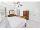 Bedroom featuring a window, tray ceiling, carpet, and wooden furniture at 100 S Sunset Ridge Dr, Willow Springs, NC 27592