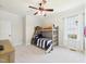 Bright bedroom with a bunk bed, ceiling fan, and a window with natural light at 100 S Sunset Ridge Dr, Willow Springs, NC 27592