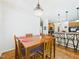Bright dining area with wood table and seating, adjacent to the kitchen with bar seating at 100 S Sunset Ridge Dr, Willow Springs, NC 27592