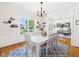 Dining room featuring a white table, chandelier, and window view at 100 S Sunset Ridge Dr, Willow Springs, NC 27592