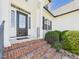 Close-up of the front entrance featuring a decorative door and brick steps at 100 S Sunset Ridge Dr, Willow Springs, NC 27592