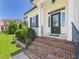Attractive entryway with brick steps, lush greenery, and a decorative front door at 100 S Sunset Ridge Dr, Willow Springs, NC 27592