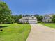 Charming single-Gathering home with a manicured front lawn and inviting driveway at 100 S Sunset Ridge Dr, Willow Springs, NC 27592