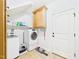 Functional laundry room with a washer, dryer, storage cabinets, and a door to the outside at 100 S Sunset Ridge Dr, Willow Springs, NC 27592