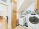 Well-organized laundry room with ample storage, including a tall cabinet and overhead shelving at 100 S Sunset Ridge Dr, Willow Springs, NC 27592