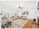 Open living room with hardwood floors, fireplace, and colorful rug at 100 S Sunset Ridge Dr, Willow Springs, NC 27592
