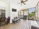 Relaxing screened porch with a TV, seating and space, perfect for outdoor entertainment and leisure at 100 S Sunset Ridge Dr, Willow Springs, NC 27592