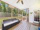 Charming screened-in porch with comfortable seating, offering a serene view of the backyard at 100 S Sunset Ridge Dr, Willow Springs, NC 27592