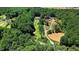 Aerial view of a property with lush greenery, a pond, and a winding driveway at 10031 Old Middlesex Rd, Middlesex, NC 27557