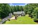 Aerial view of a home showcasing its landscaped yard, separate garage, and peaceful setting among mature trees at 10031 Old Middlesex Rd, Middlesex, NC 27557