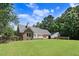 Spacious backyard with lush green grass and a charming brick home in a private setting at 10031 Old Middlesex Rd, Middlesex, NC 27557