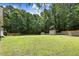 Expansive, well-maintained backyard featuring lush green grass, mature trees, and a privacy fence at 10031 Old Middlesex Rd, Middlesex, NC 27557