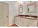Elegant bathroom featuring double sinks, granite countertops, and decorative mirrors at 10031 Old Middlesex Rd, Middlesex, NC 27557