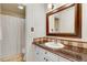 Cozy bathroom features a vanity with granite counter, single sink, and shower at 10031 Old Middlesex Rd, Middlesex, NC 27557