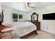 Comfortable bedroom with a large window, ceiling fan, and TV for relaxation at 10031 Old Middlesex Rd, Middlesex, NC 27557