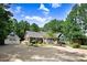 Beautiful home featuring lush landscaping and a spacious driveway leading to a detached two-car garage and shed at 10031 Old Middlesex Rd, Middlesex, NC 27557