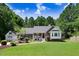Charming home with a well-manicured lawn and inviting curb appeal, framed by mature trees and a detached garage at 10031 Old Middlesex Rd, Middlesex, NC 27557