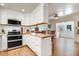 Open kitchen featuring butcher block countertops, white cabinets, stainless steel appliances, and hardwood floors at 10031 Old Middlesex Rd, Middlesex, NC 27557
