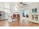 Bright open kitchen with breakfast bar seating, white cabinets, stainless steel appliances, and hardwood floors at 10031 Old Middlesex Rd, Middlesex, NC 27557