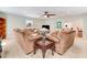 Comfortable living room with neutral carpet, a ceiling fan, and multiple seating areas for a relaxed atmosphere at 10031 Old Middlesex Rd, Middlesex, NC 27557