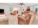 Spacious living room with plush sofas, neutral carpet, and natural light, perfect for relaxing and entertaining guests at 10031 Old Middlesex Rd, Middlesex, NC 27557
