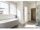 Modern bathroom features soaking tub, walk-in shower, and plenty of natural light at 1009 Parker St, Raleigh, NC 27607