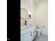 Modern powder room featuring stylish mirror, white vanity, and patterned tile floor at 1009 Parker St, Raleigh, NC 27607